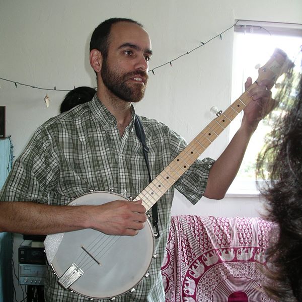 man in a plaid shirt playing a banjo