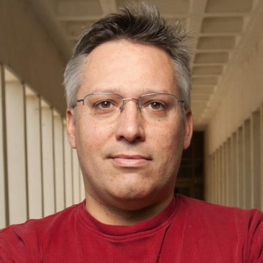 headshot of delmar larsen in a red shirt