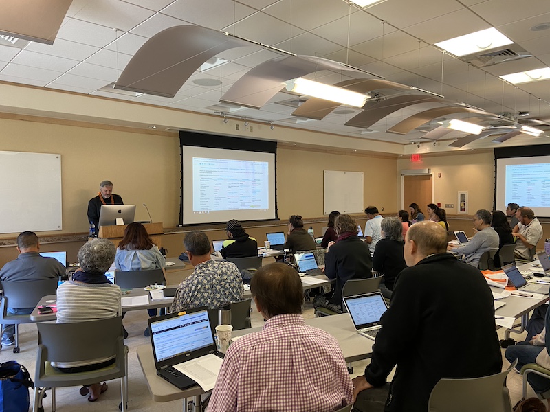 workshop with many people at round tables