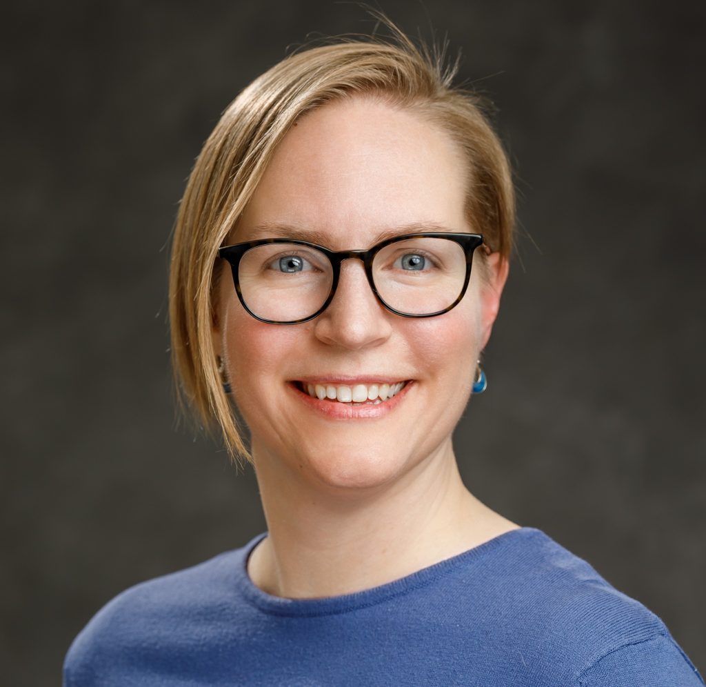 headshot of blonde woman with glasses